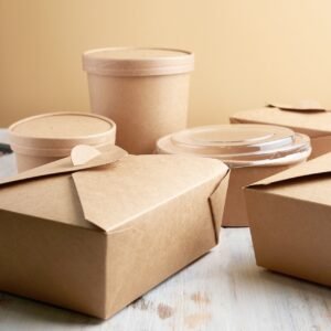 paper containers for takeaway food, isolated on a wooden table