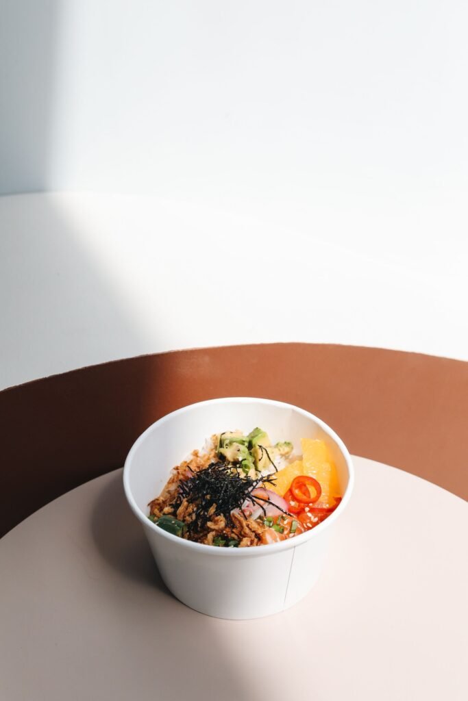 Delicious poke bowl featuring fresh avocado, chilies, and vegetables, perfect for a healthy meal.